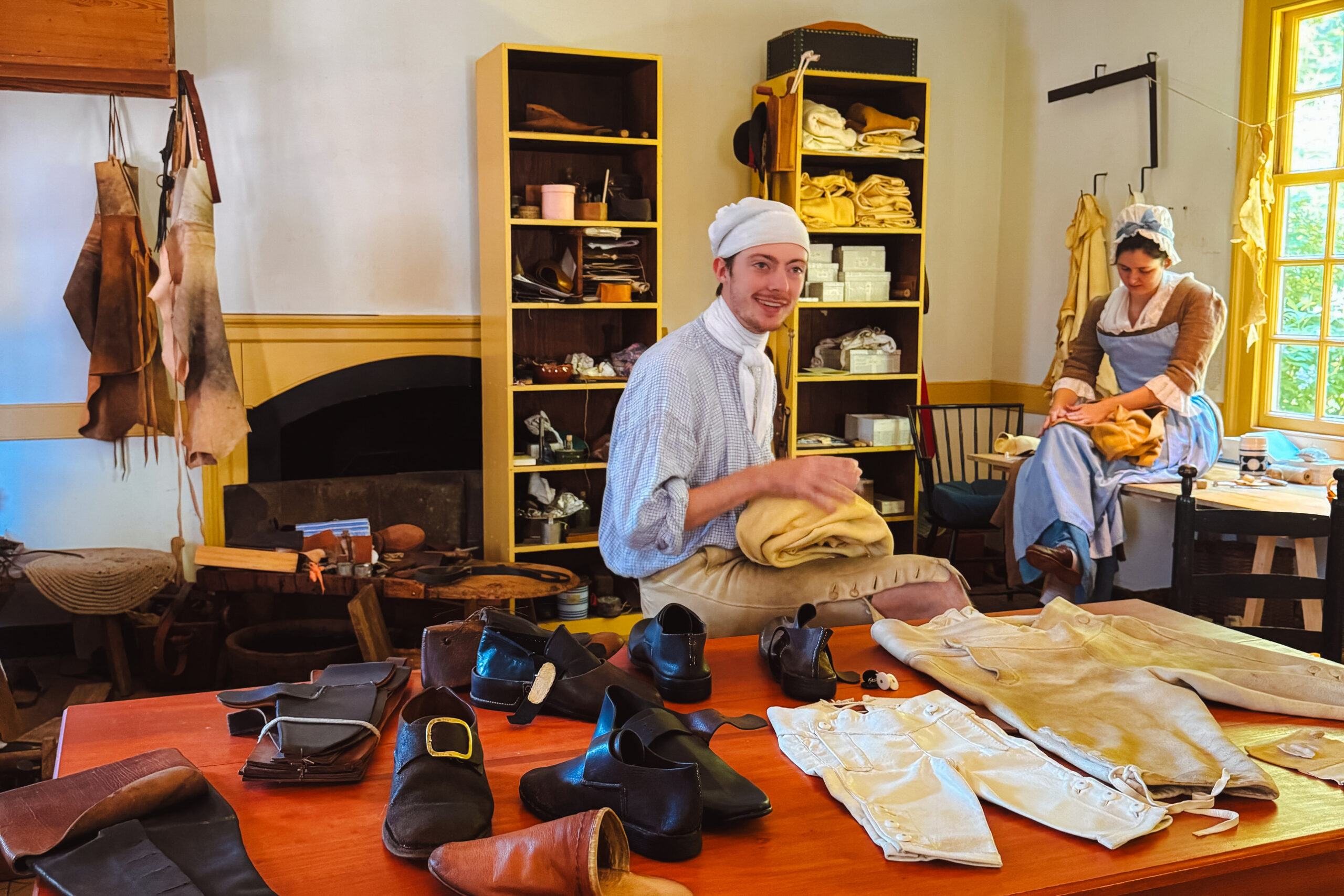 Costumed interpreters reenacting daily life in the 18th century at Colonial Williamsburg, a living history museum.